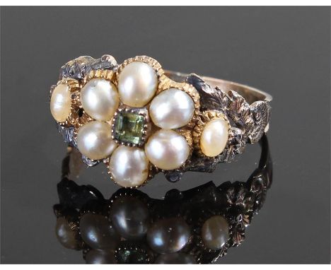 Late 18th/early 19th Century pearl ring, the pearls set around a peridot with an engraved foliate shoulder, ring size M