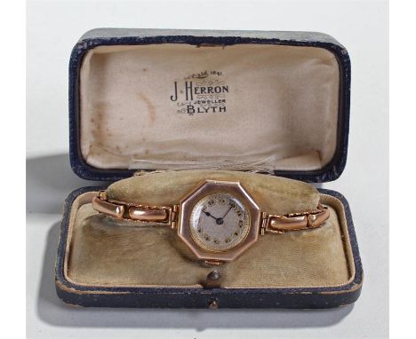 9 carat gold ladies wristwatch, the silvered dial with Arabic hours, hexagonal case, manual wound, with a 9 carat gold elasti
