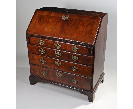 George II walnut bureau, the inlaid, fall front, opening to reveal a fitted interior of drawers and pigeon holes over four dr