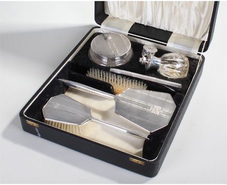 Elizabeth II silver dressing table set, Birmingham 1959, consisting of a glass and silver topped container, a perfume bottle,