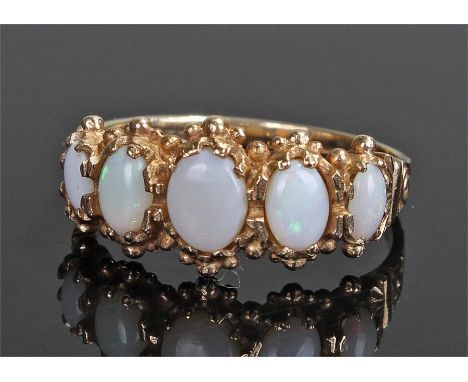 9 carat gold opal set ring, set with five opals to the head on a tapering shank, ring size U