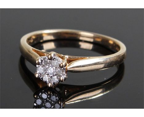 9 carat gold, diamond set ring, the diamonds forming a flower head design, ring size L
