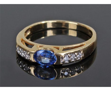 18 carat gold sapphire and diamond ring, the oval sapphire flanked by three diamonds to either shoulder, ring size P