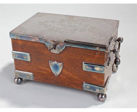 Victorian silver plated and oak tea caddy, in the form of a strapped chest with silver plated brackets, handles and lid on ba