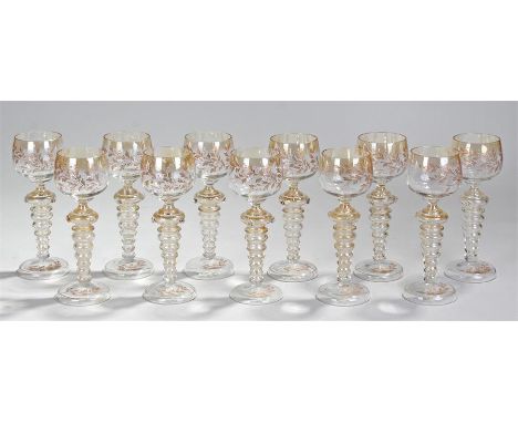 12 Hock glasses, the bowls decorated in gilt and enamel with leaves and berries over a ribbed stem with applied prunts 