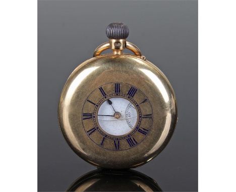18 carat gold half hunter pocket watch, the central opening surrounded by enamelled Roman numerals opening to reveal a white 