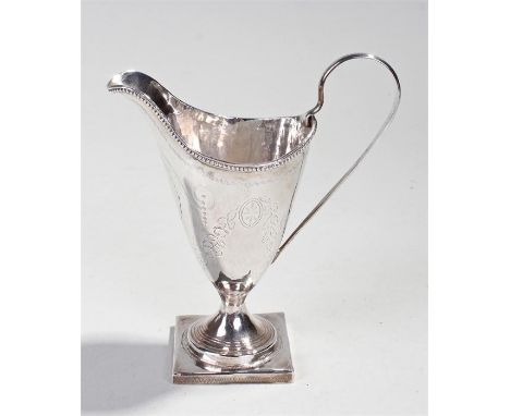 George III silver helmet shaped cream jug, London 1787, makers mark obscured, of typical form and engraved with floral swags,