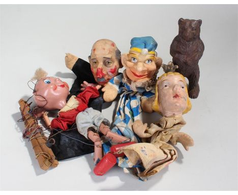 Toys, to include a strung puppet and three hand puppets and an iron bear money bank, (5)