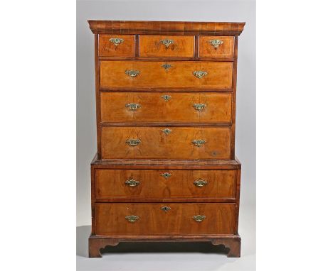 18th Century walnut chest on chest, the concave top above three short and three long drawers each with banding, above an arch