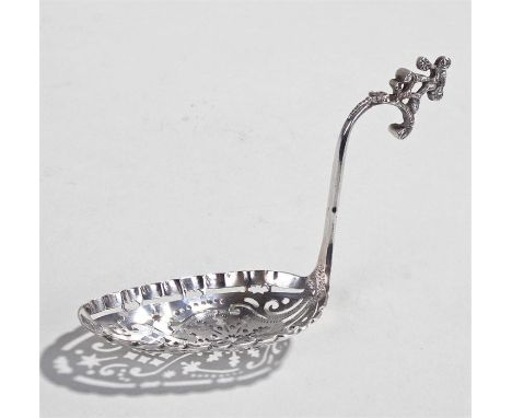 19th Century Dutch silver sifter spoon, a figure above an arched handle leading to a pierced bowl, 28 grams