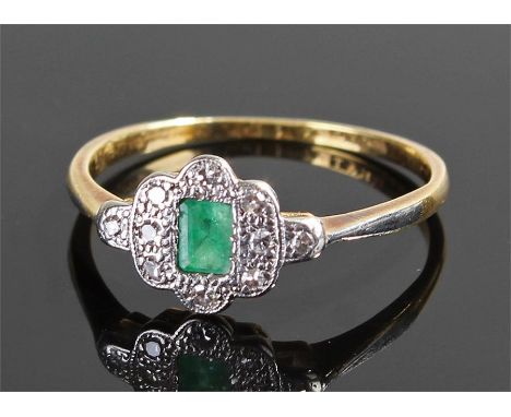 18 carat gold diamond and emerald ring, the central emerald surrounded by diamonds to the platinum head, ring size Q