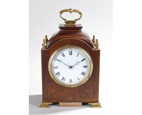 French inlaid mahogany clock, the gilt metal handle above a squat shaped pagoda top, ribbon inlaid front and ogee feet, the w