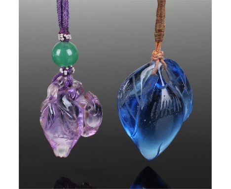 Chinese carved amethyst pendant, the fruit carved with draped leaves and an animal to the side, a jade sphere to the string, 