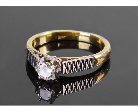 18 carat gold diamond ring, the diamond at approximately 0.20 carat flanked by platinum zigzag design shoulders, ring size K