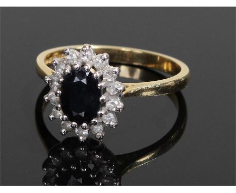18 carat gold sapphire and diamond ring, the central sapphire surrounded by diamonds, ring size N