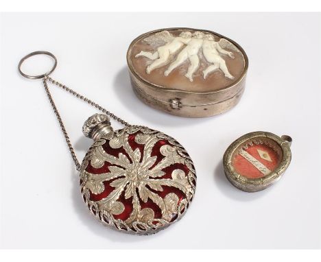 19th Century white metal cameo snuff box, carved with three cherubs to the lid, together with a white metal and red glass sce