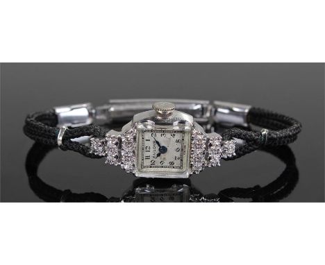 Bulova ladies 14 carat white gold and diamond set wristwatch, the square signed dial with Arabic hours, diamonds set to a tri