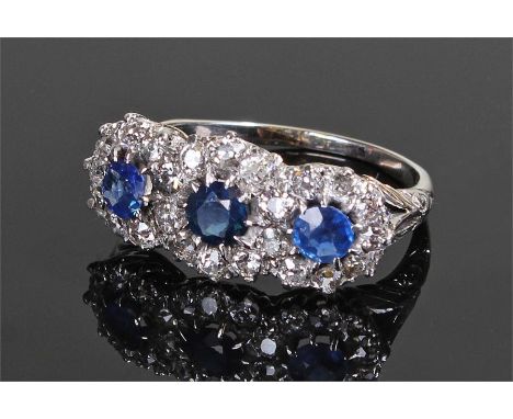 Sapphire and diamond set white gold ring, set with three sapphires surrounded by diamonds, ring size P