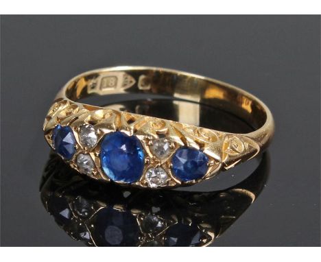 18 carat gold sapphire and diamond ring, the ring set with three sapphires and four diamonds, ring size R