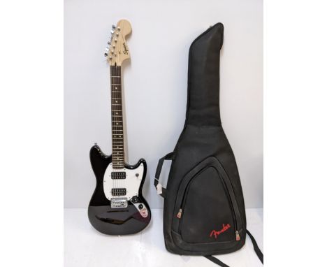 A Squier by Fender Mustang six-string electric guitar in black and white serial no. ICS 18289177 with Fender case Location:RA