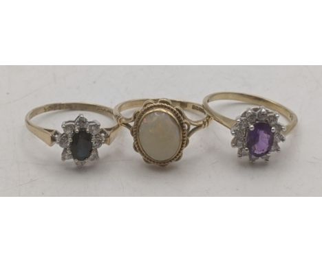 Three 9ct gold ladies rings to include a opal solitaire together with two 9ct yellow and white gold cluster dress rings, one 