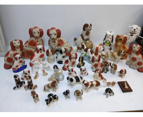 A collection of ceramic dog figurines to include a large pair of Staffordshire style examples, a modern Chinese ornament of a