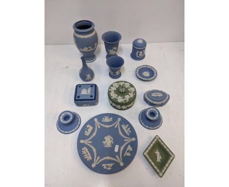 A collection of blue and green Wedgwood jasperware items to include an urn shaped vase, a pair of candlesticks, a trinket box