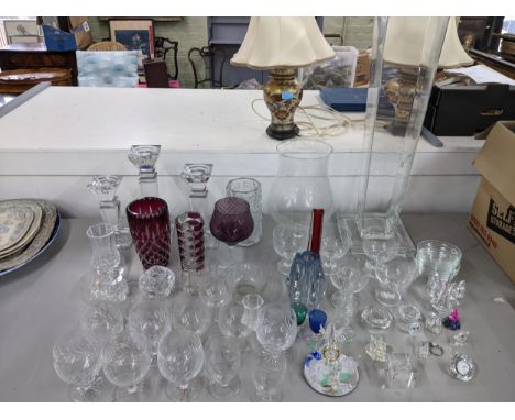 A selection of glassware to include a Whitefriars ruby tricorn vase, Swarovski crystal ornaments, and a graduated set of cand