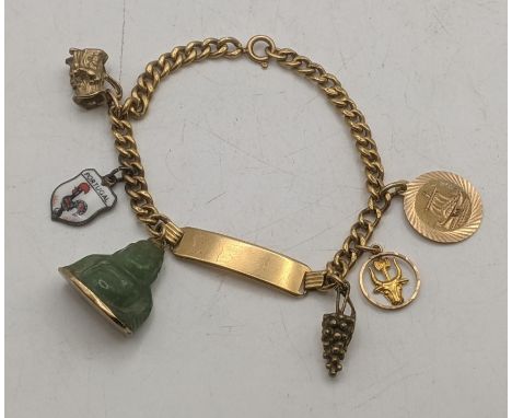 An 18ct gold identity bracelet with charms to include a 9ct gold 'Toby Jug' charm, a 9ct gold 'grape' charm, a 14ct gold and 