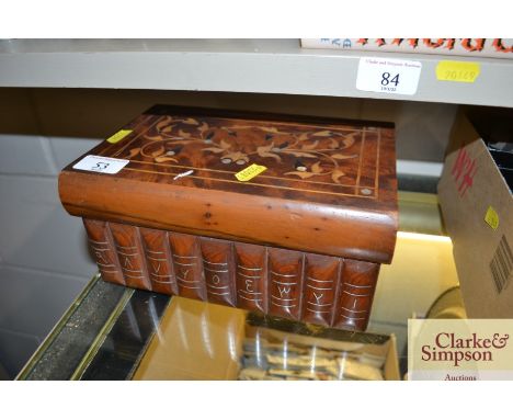 An inlaid hardwood trinket box in the form of a book