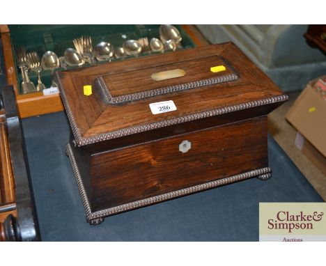 A Victorian rosewood sarcophagus shaped tea caddy with mother of pearl inlay