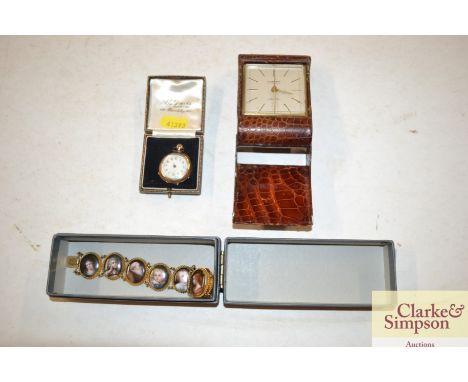 An 18ct gold fob watch AF; a travelling clock; and a bracelet with portrait panels