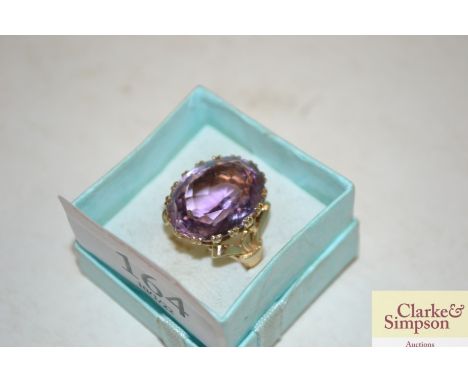 A 9ct gold and amethyst coloured set ring 