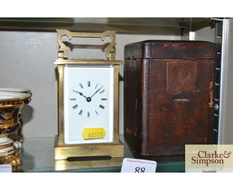 A brass cased carriage clock in leather fitted case AF