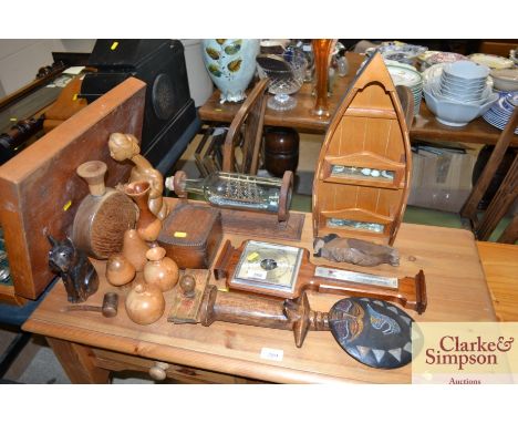A collection of various wooden ware, barometer, ship in  a bottle ornament, Ethnic fertility symbol etc. 
