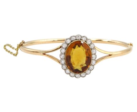 Early 20th century 15ct rose gold oval citrine and milgrain set old cut diamond hinged bangle, total diamond weight approx 1.