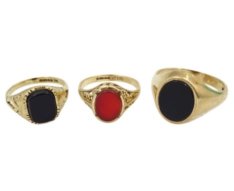 Two gold black onyx signet rings and an oval carnelian signet ring, all hallmarked 9ctCondition Report:Approx 10.5gm, ring si