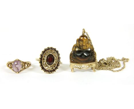 A 9ct gold single stone amethyst ring, with pierced shoulders, 2.12g, size K, a gold garnet ring, a single oval cut garnet wi