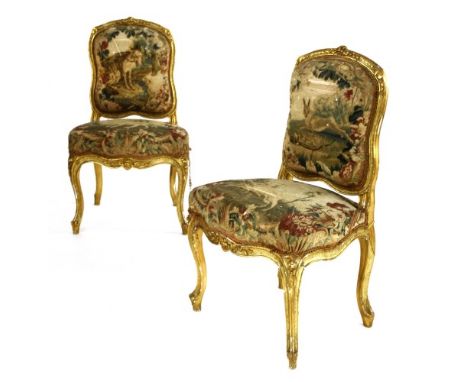 A pair of Louis XV style transitional giltwood side chairs, c.1870, with carved foliate frames and Aubusson tapestry upholste