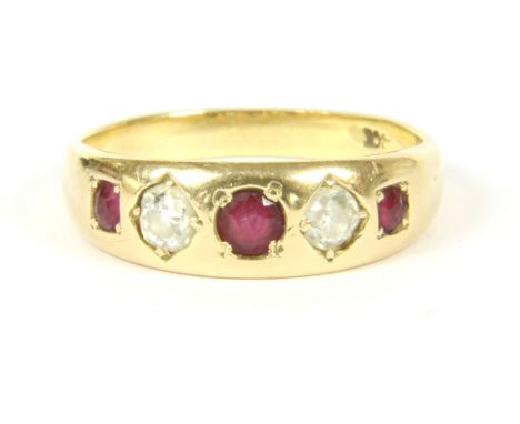 A gold five stone graduated ruby and diamond ring, (tested as approximately 18ct gold), 4.37g