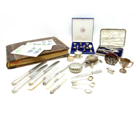 A collection of silver items , to include a ring box, toast rack and flatware together with a stamp album, predominantly QEII