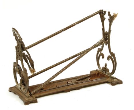 A Victorian cast iron stick stand, possibly Coalbrookdale, the divisioned section on waisted end supports with drip pan set i