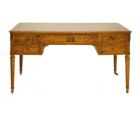 A satinwood desk, late 19th century, the shaped top over a central frieze drawer flanked on each side by two drawers, the cor