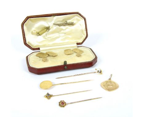 A 9ct gold St Christopher pendant, a cased pair of 9ct cufflinks and studs, a one dollar stick pin, a 9ct gold red paste ston