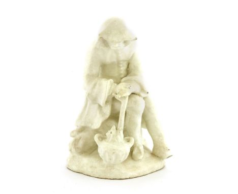 A Bow white-glazed figure representing winter, c.1755, an old man, seated and leaning on a stick by a brazier, 12.5cm high