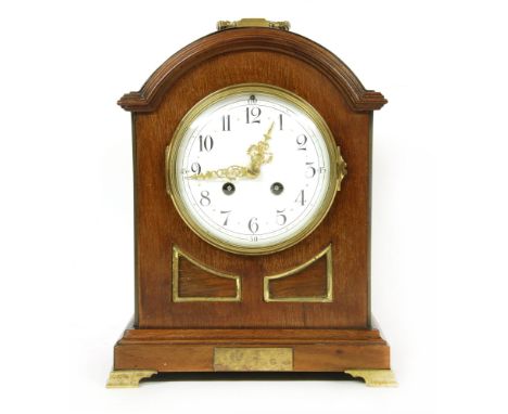 A late 19th century mahogany mantle clock, with arched pediment and white enamel dial and Arabic numeral markers, 28cm high