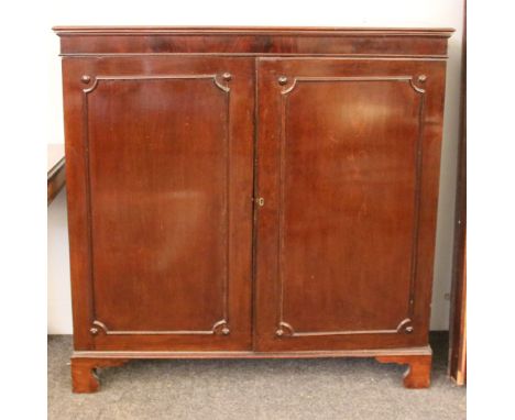 A George III mahogany dwarf bookcase, having moulded top above two panel doors on bracket feet, 120cm wide, 43cm deep, 123cm 