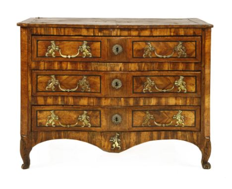 A North European olivewood serpentine commode chest, 18th century, possibly Maltese the shaped quarter veneered top over thre