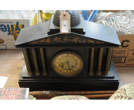 A Victorian architectural black slate mantel clock with a gilt metal dial and gilt metal fruit finial.