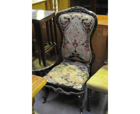 A Victorian rosewood drawing room chair with a padded tapestry back and seat.